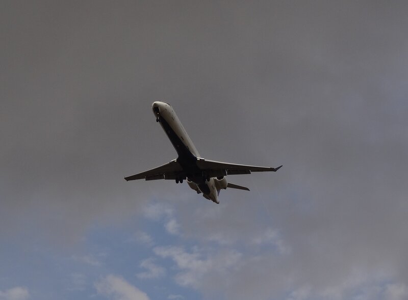 Airplane in Flight — Gray, Dramatic, Afternoon