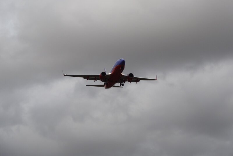 Airplane in Flight — Gray, Overcast, Photograph, Clouds, Wings