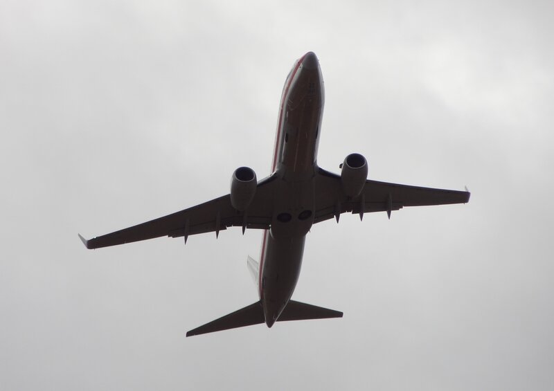 Airplane in Flight — Gray, Overcast, Photograph