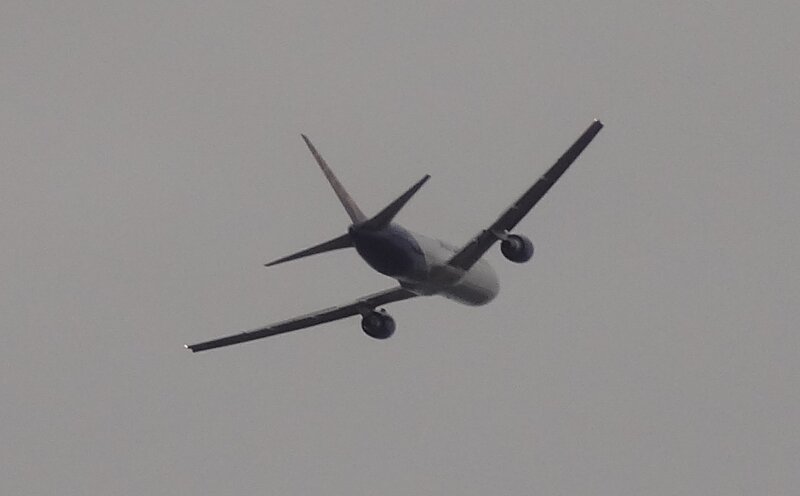 Airplane in Flight — Gray, Overcast