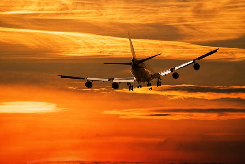 Airplane in Flight — Orange, Dramatic
