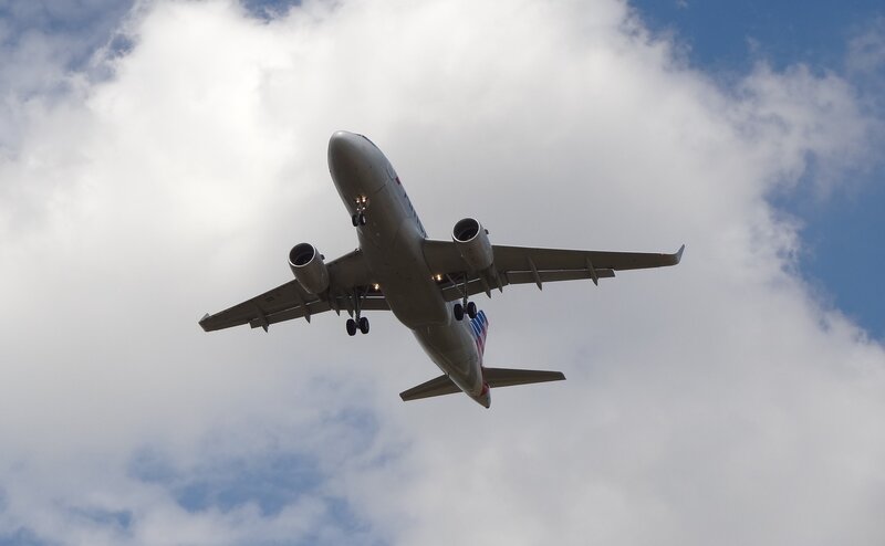 Airplane in Flight — White, Dramatic, Afternoon