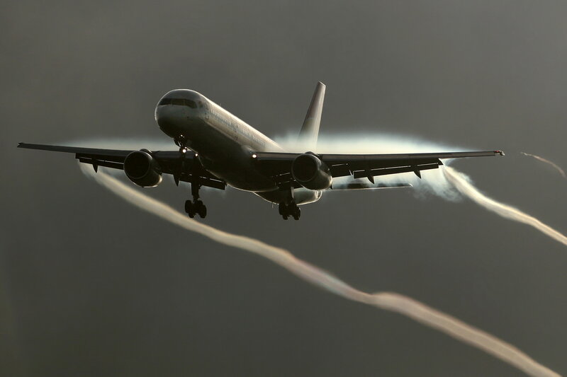 airplane in flight with contrails