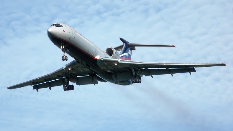 airplane in flight with landing gear down