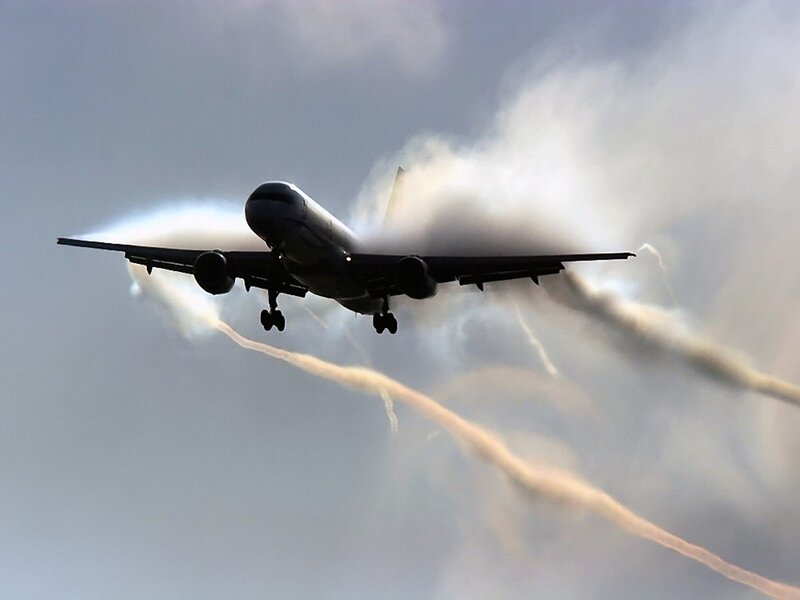Airplane in flight with vapor trails