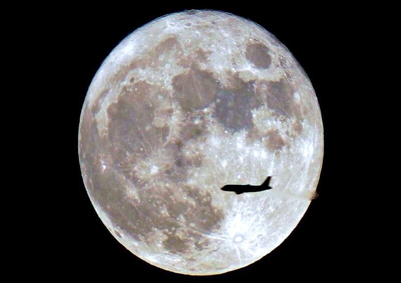 Airplane in front of the moon