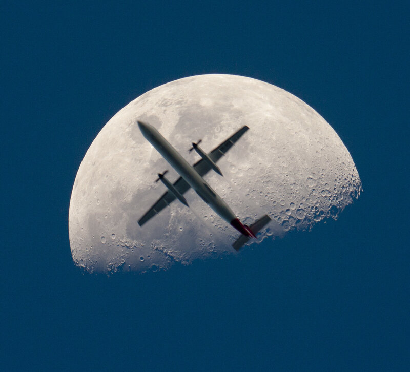 Airplane in front of the moon