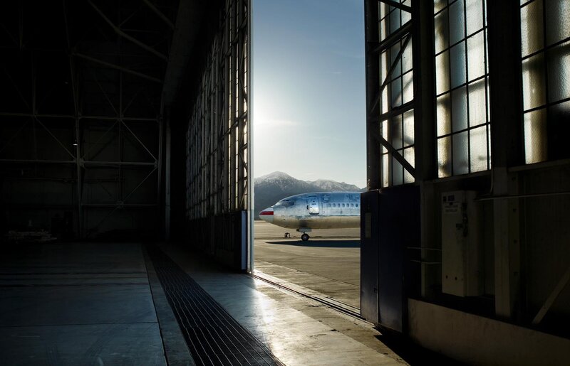 Airplane in hangar with mountains
