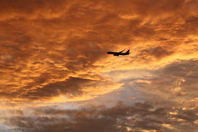 Airplane in Sunset Sky — Dramatic