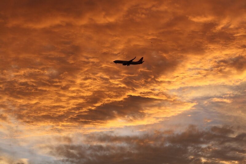 Airplane in Sunset Sky — Orange, Dramatic, Photograph, Clouds, Yellow, Brown