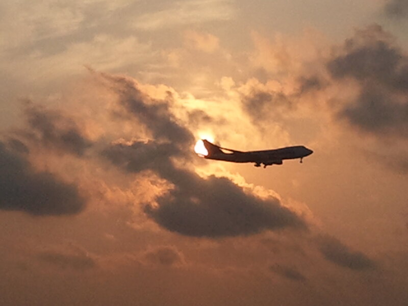 Airplane in Sunset Sky