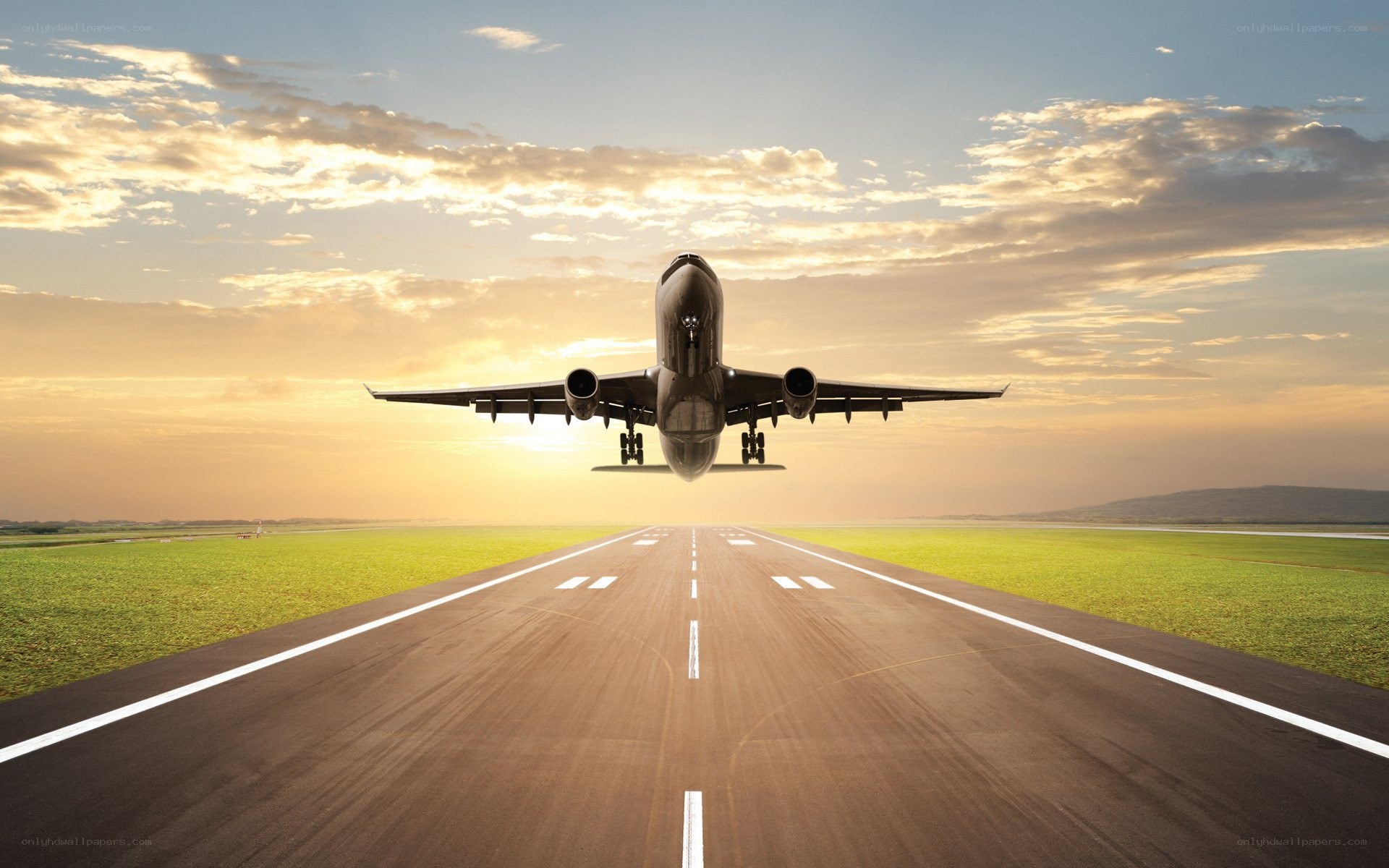 Airplane landing at sunset