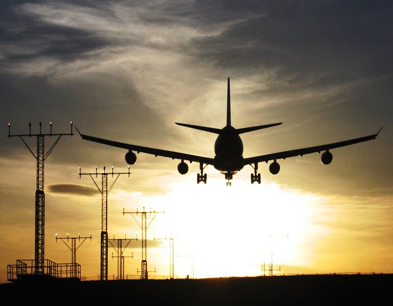 Airplane landing at sunset
