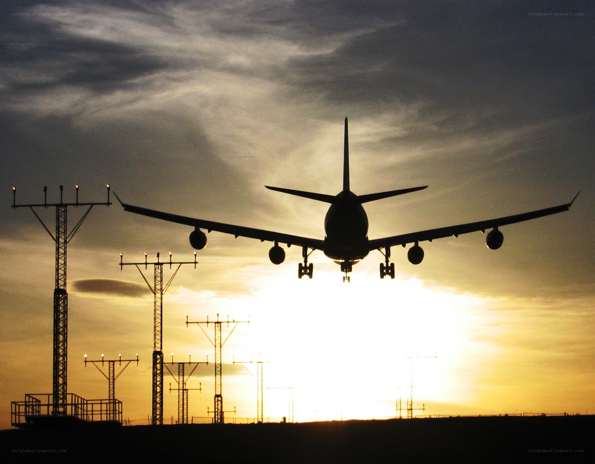Airplane landing at sunset
