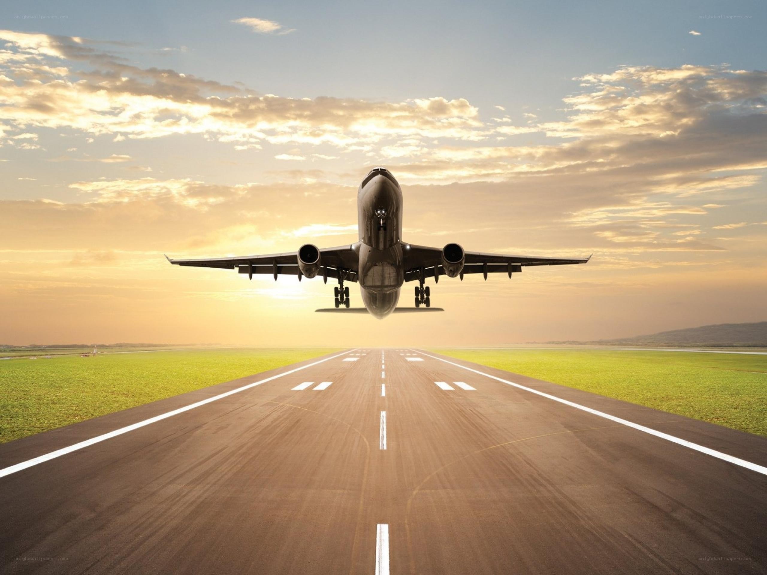 Airplane landing at sunset