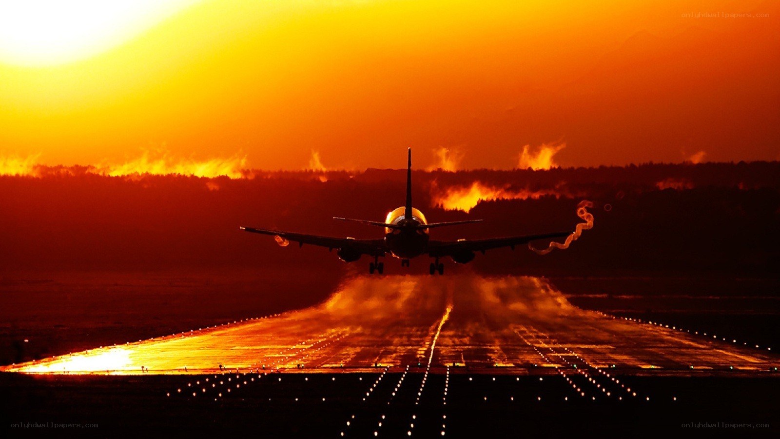 Airplane landing at sunset