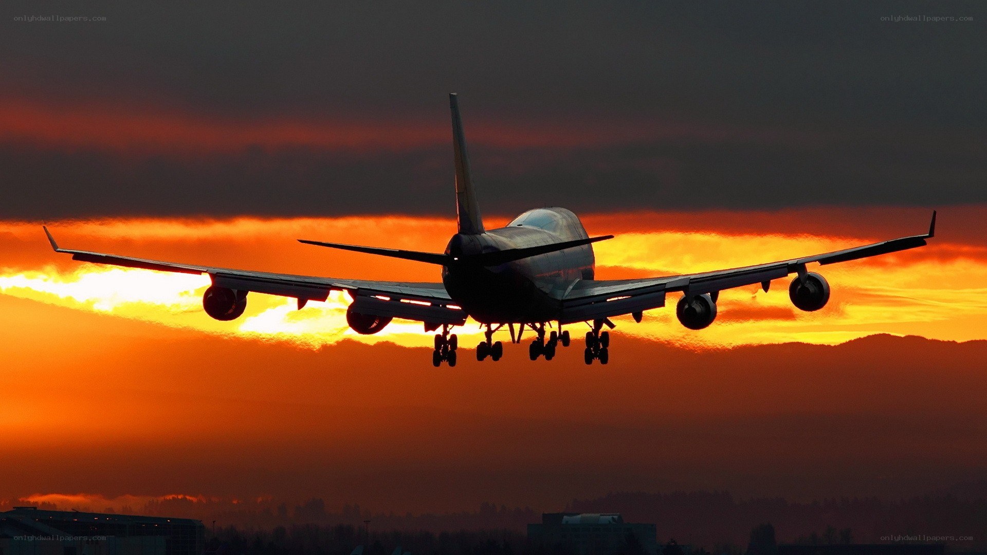Airplane landing at sunset