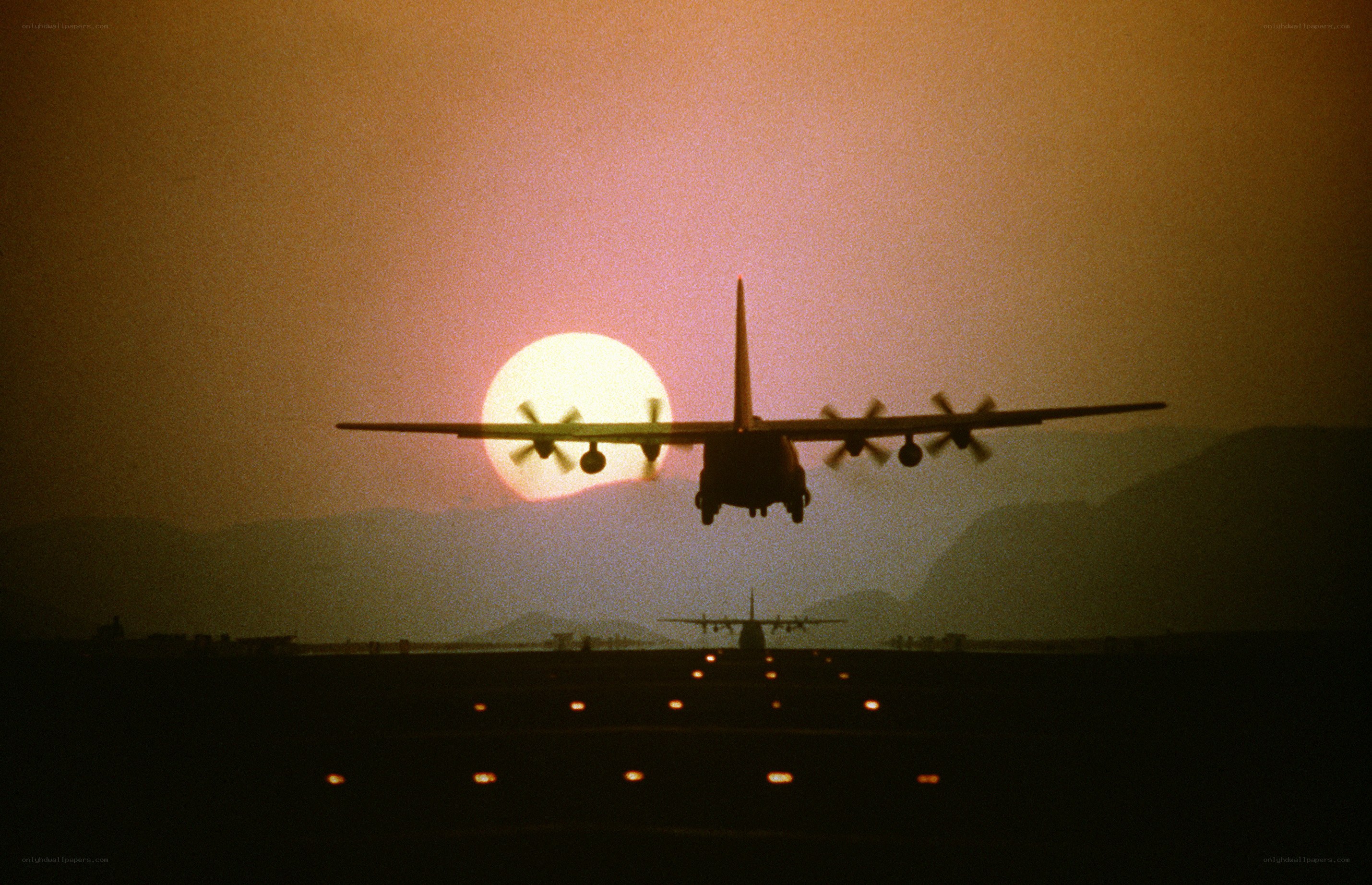 Airplane landing at sunset