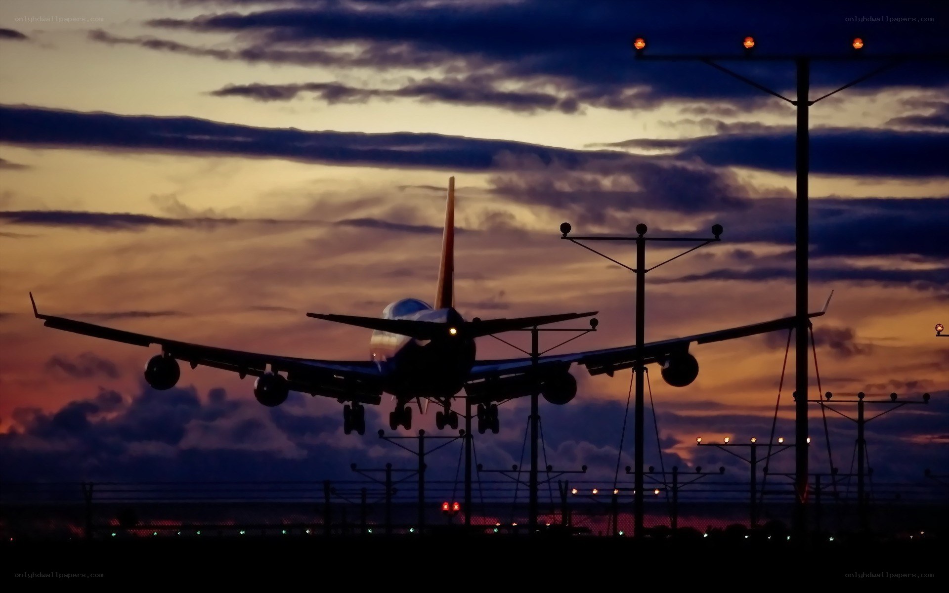 Airplane landing at sunset