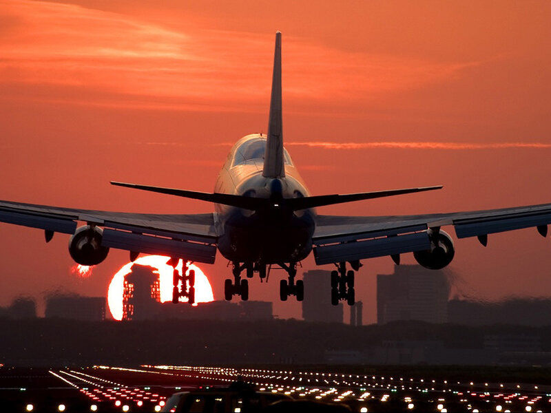 Airplane Landing at Sunset — Orange, Dramatic, Photograph, Runway Lights, City Skyline