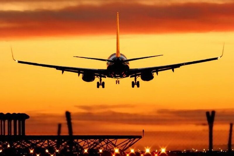 Airplane Landing at Sunset — Orange, Dramatic, Photograph