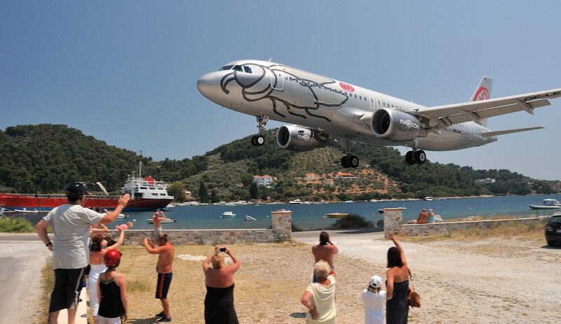 Airplane Landing Near Beach — Blue