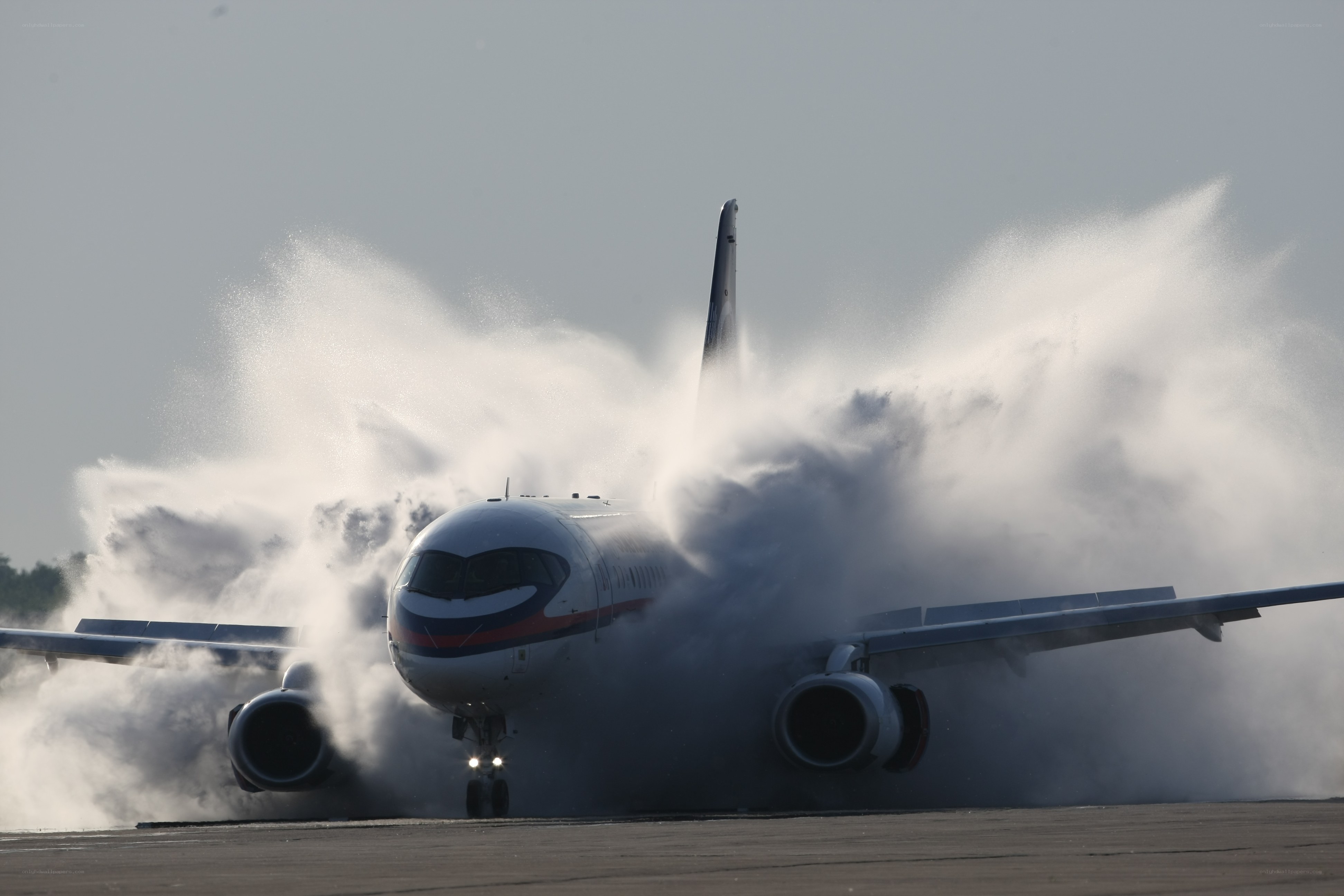 Airplane landing on wet runway