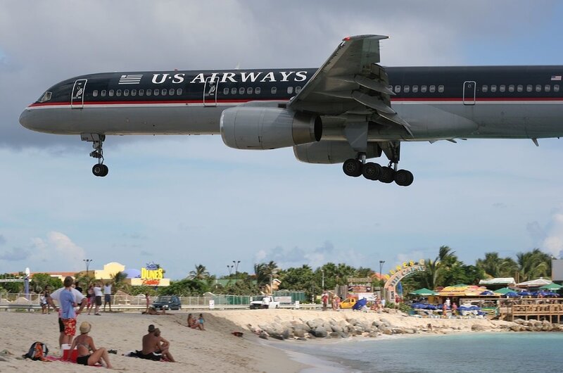 Airplane landing over beach