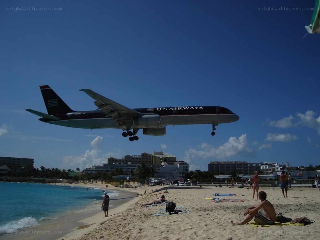 Airplane landing over beach