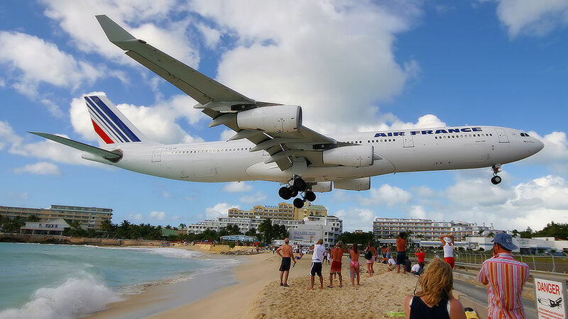 Airplane landing over beach