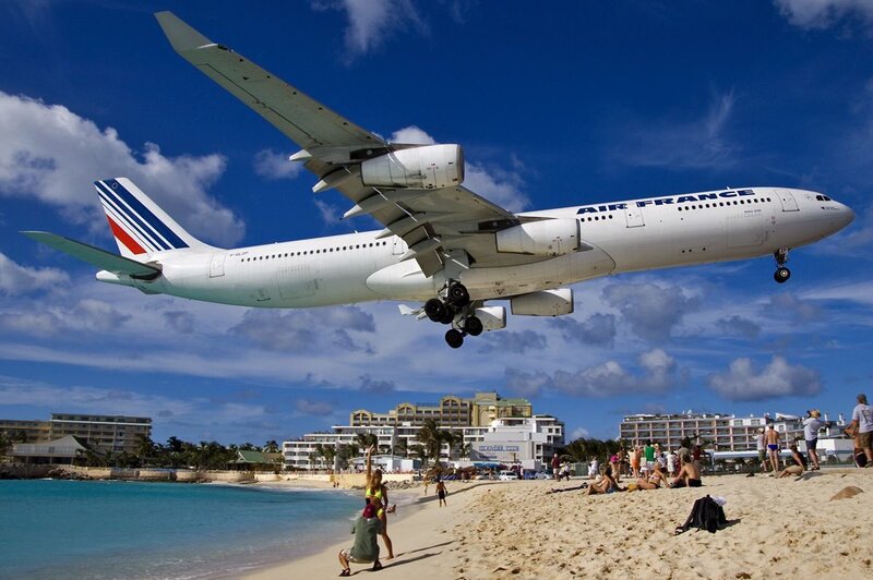 Airplane landing over beach