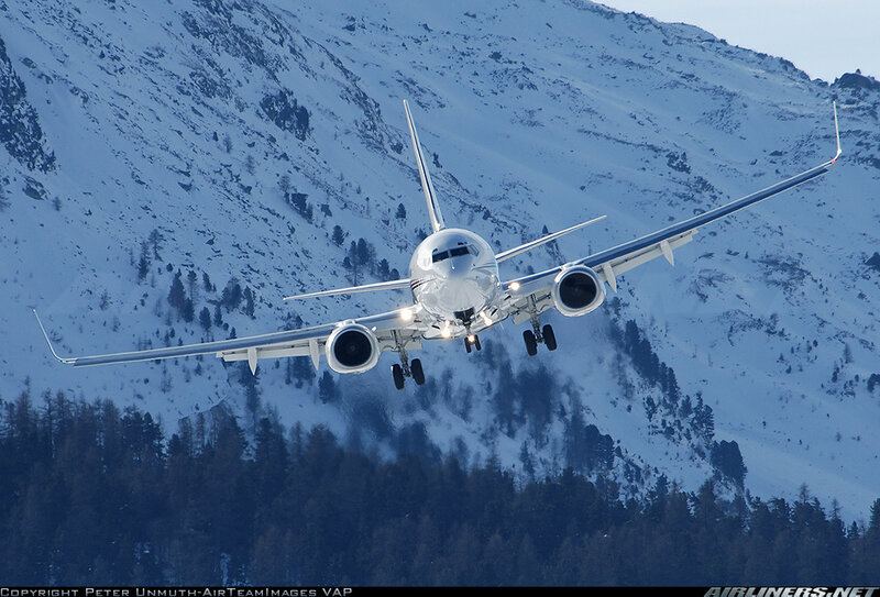 Airplane landing over snowy mountains