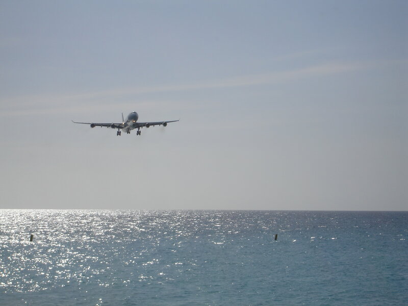 Airplane landing over the ocean