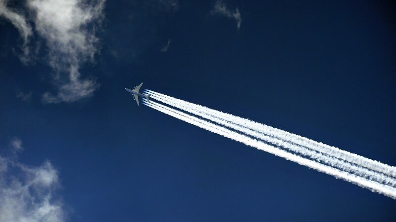Airplane leaving contrails in sky