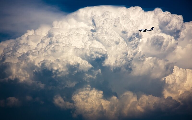 Airplane Near Storm Cloud — White