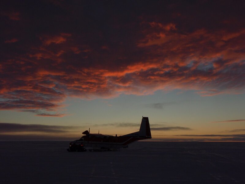 Airplane on ice at sunset