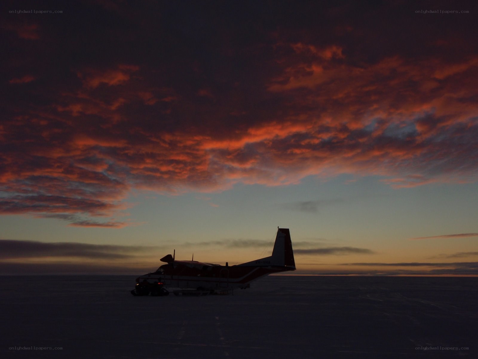 Airplane on ice at sunset