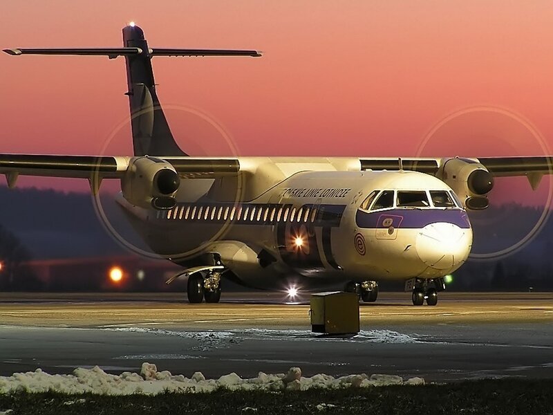 Airplane on runway at dusk