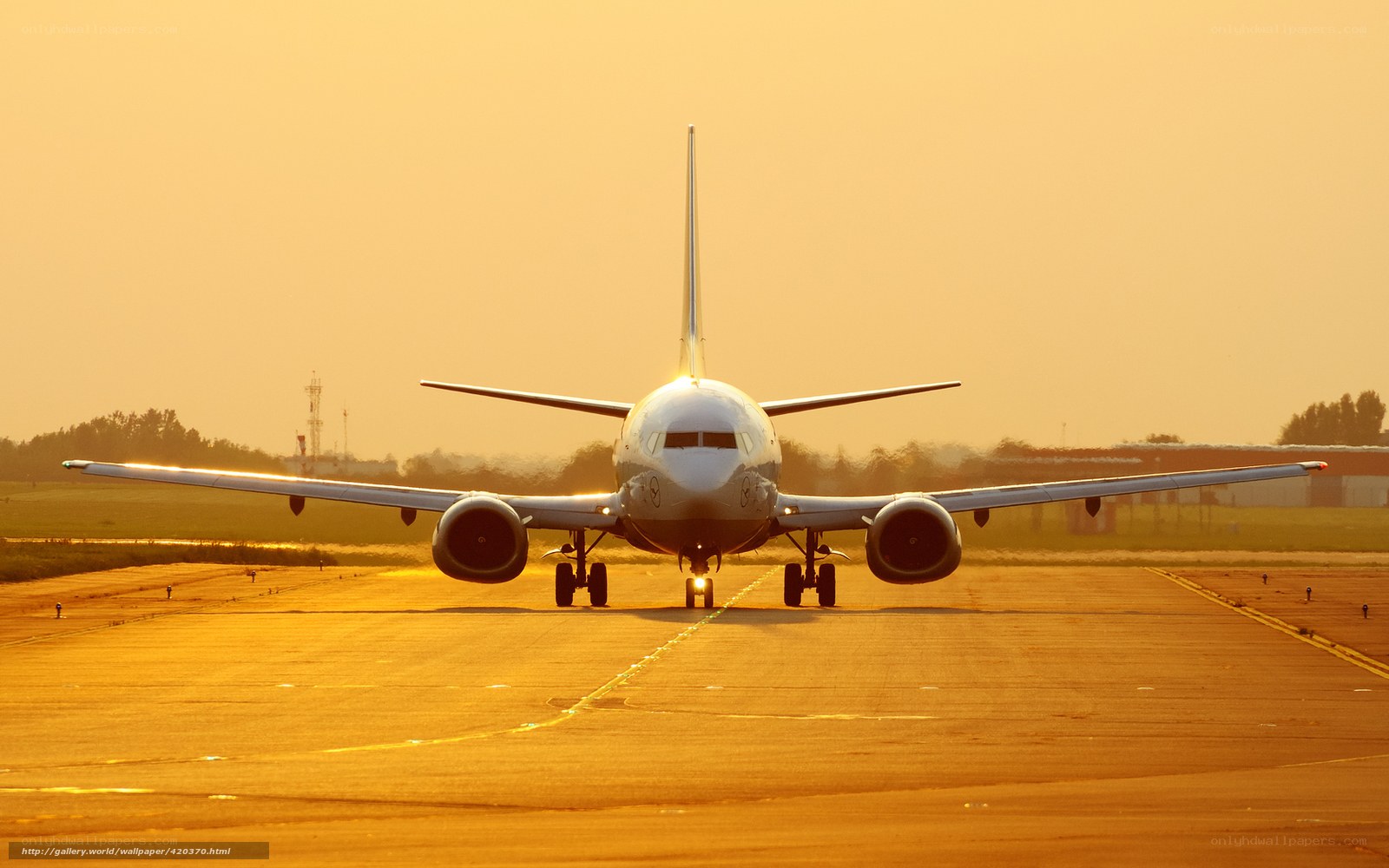 Airplane on runway at sunset