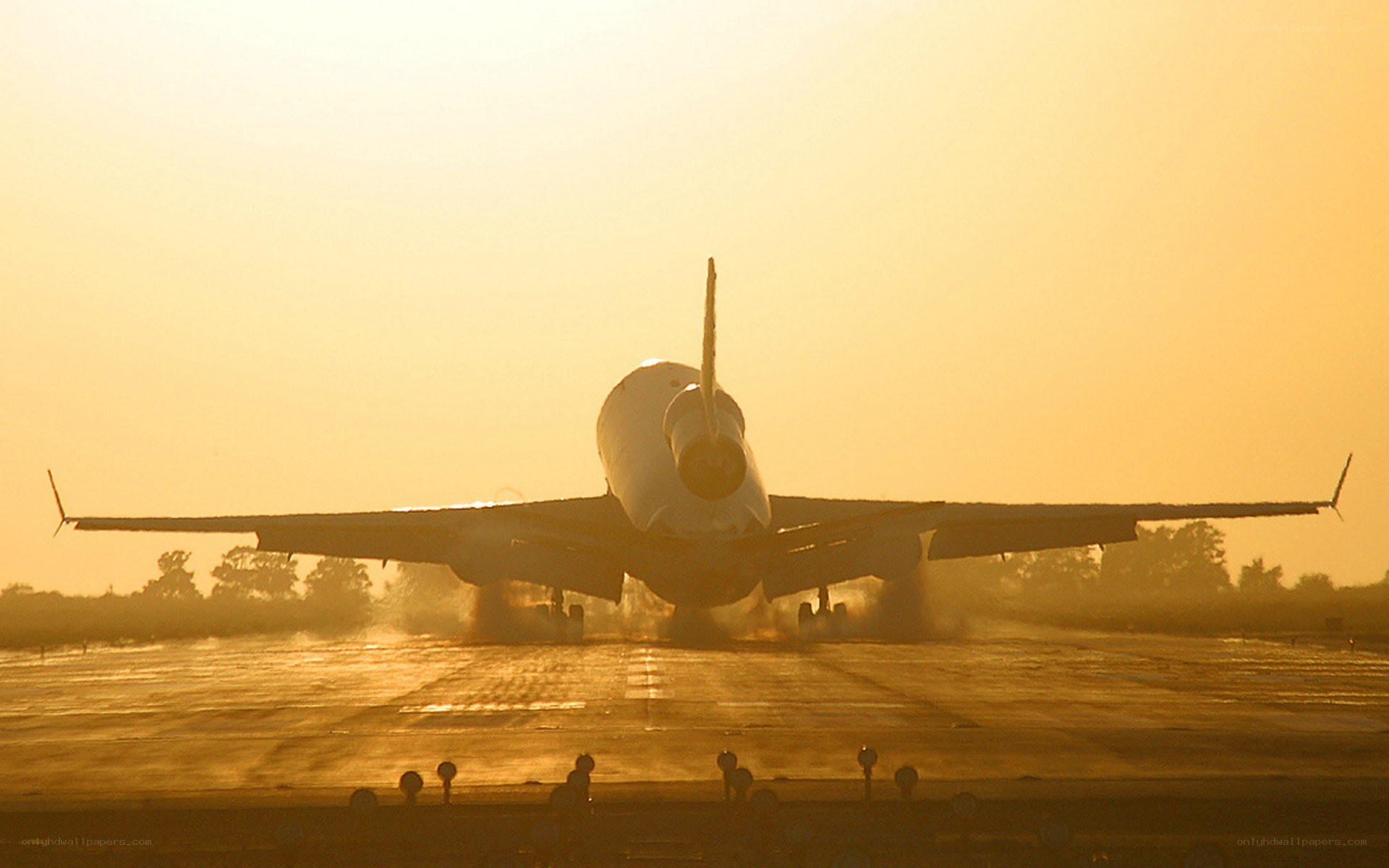 Airplane on runway at sunset