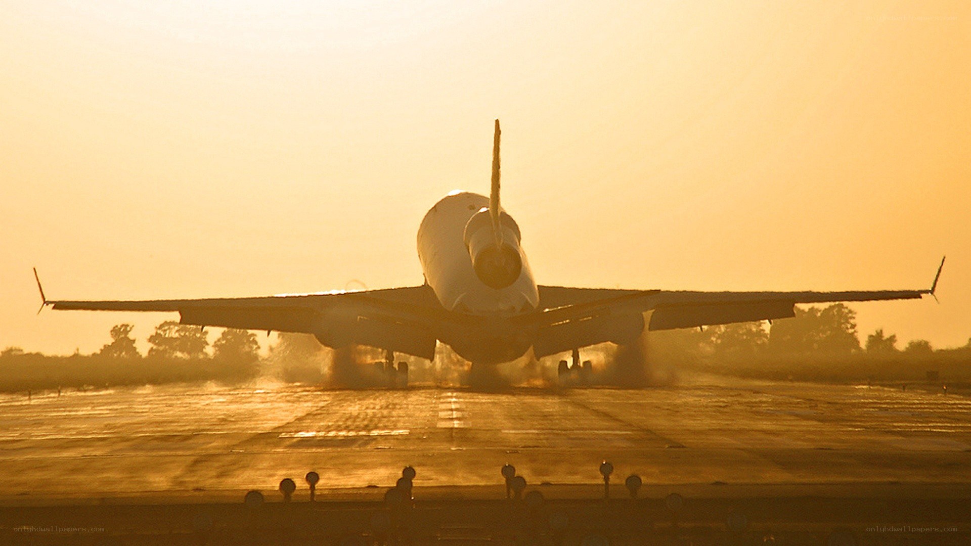 airplane on runway at sunset