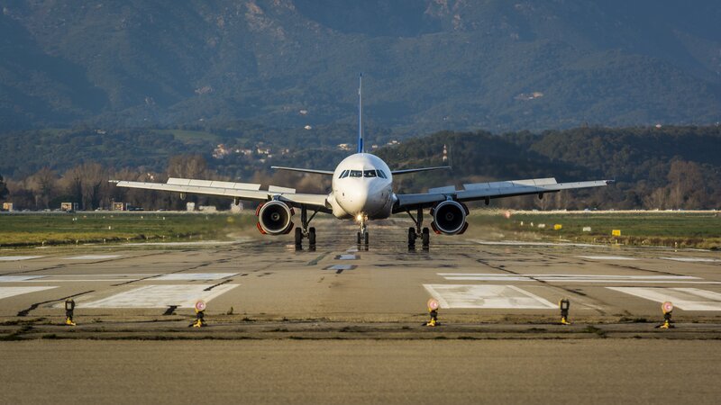 Airplane on Runway — White, Calm, Morning