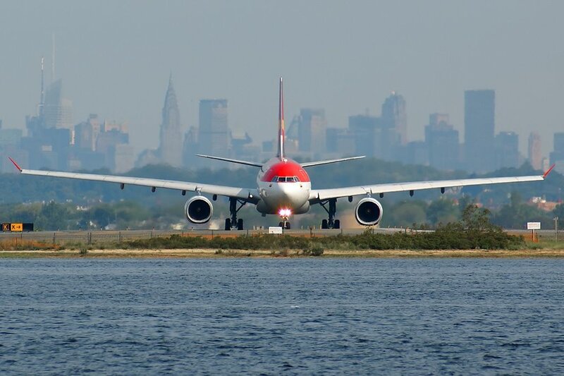 Airplane on runway with city skyline