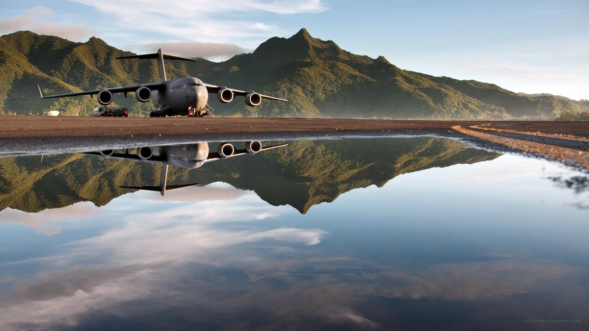 Airplane on runway with mountain reflection