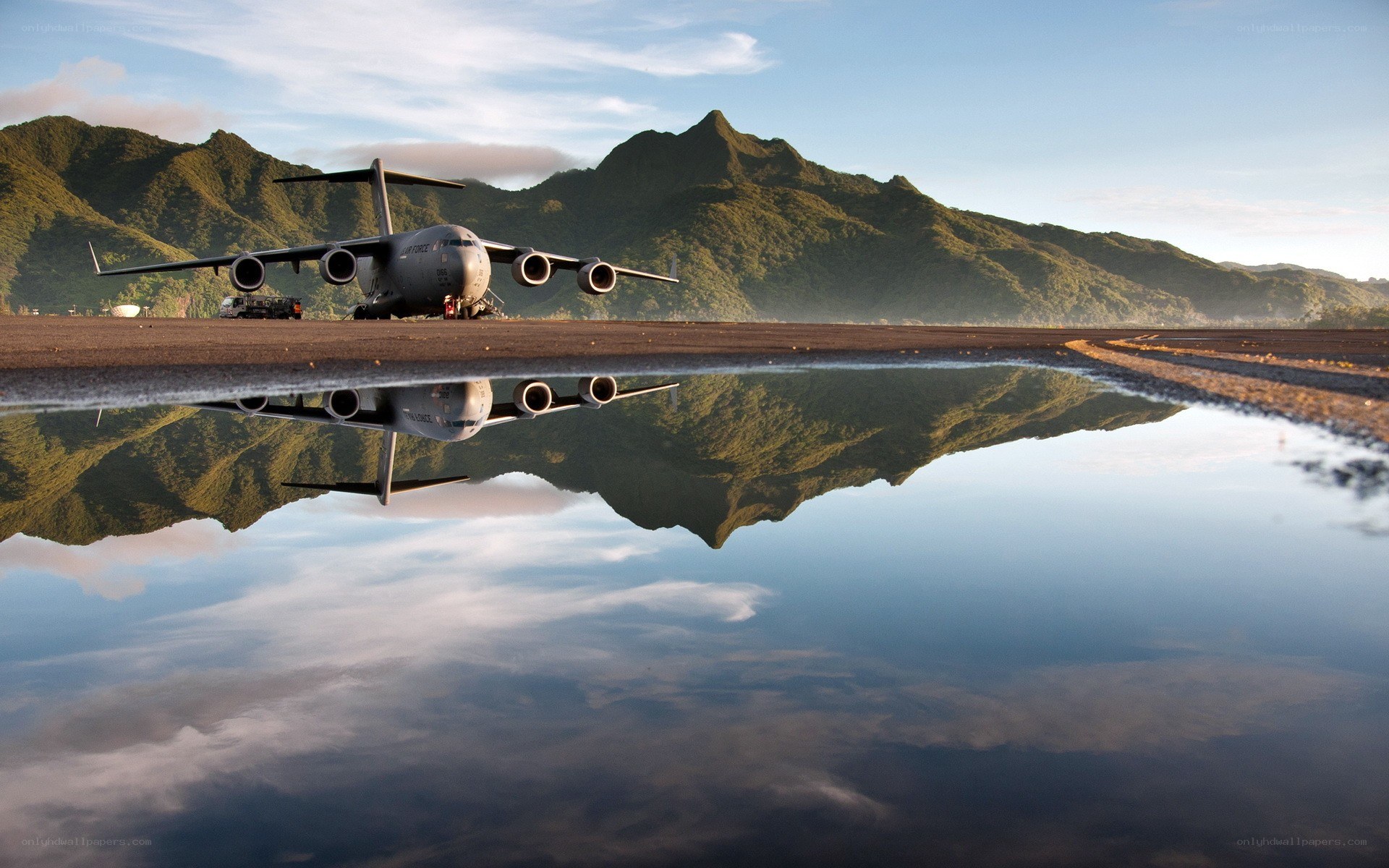 Airplane on runway with mountain reflection