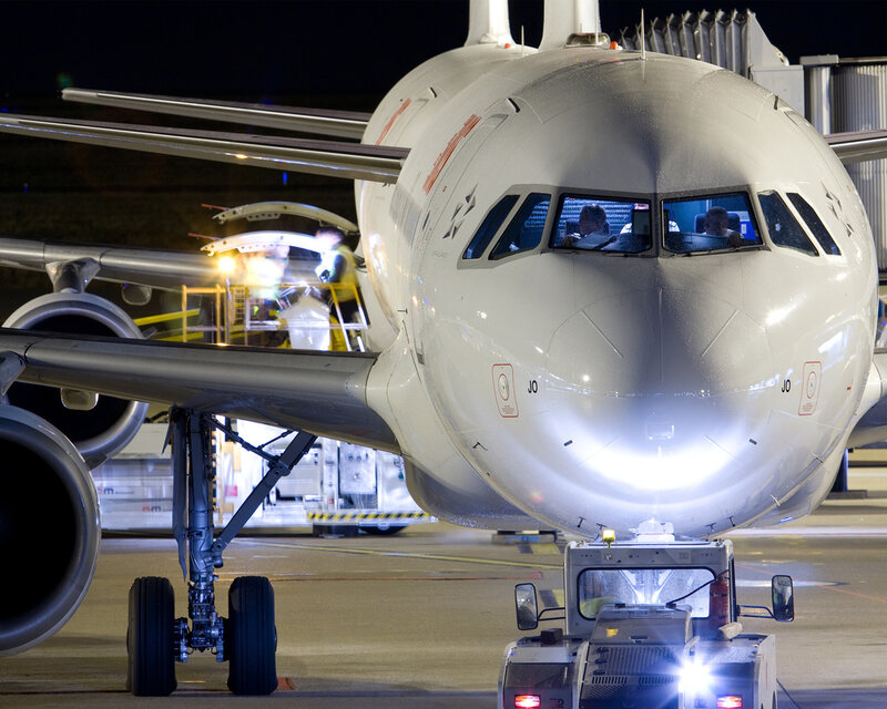 Airplane on tarmac at night