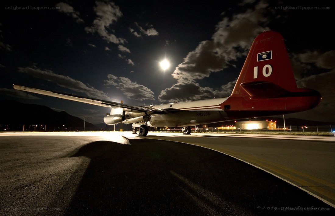 Airplane on tarmac at night