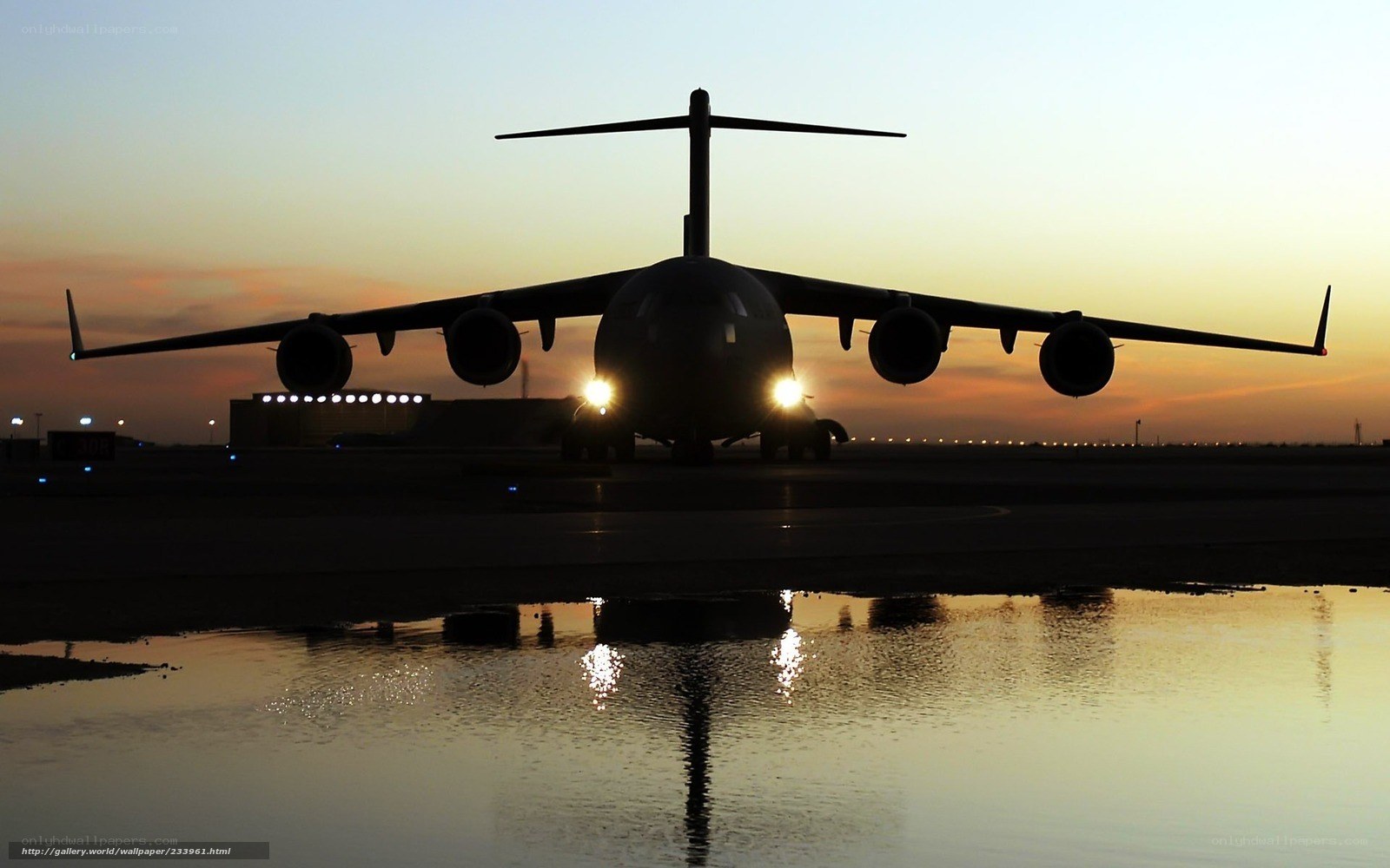 Airplane on tarmac at sunset
