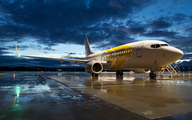 Airplane on wet tarmac at dusk