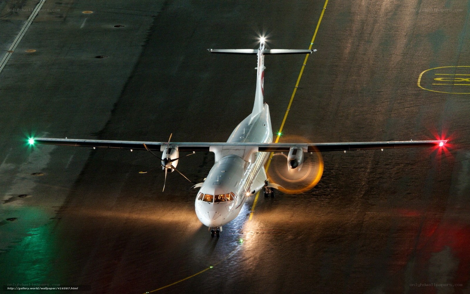 airplane on wet tarmac at night